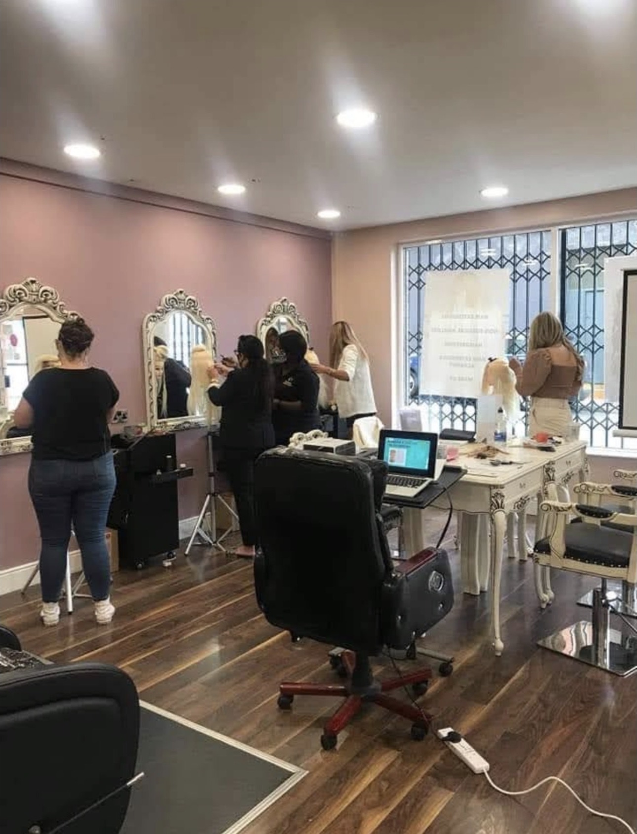 iHobbs Academy students working on mannequin heads during a practical nano extensions training session in the studio.