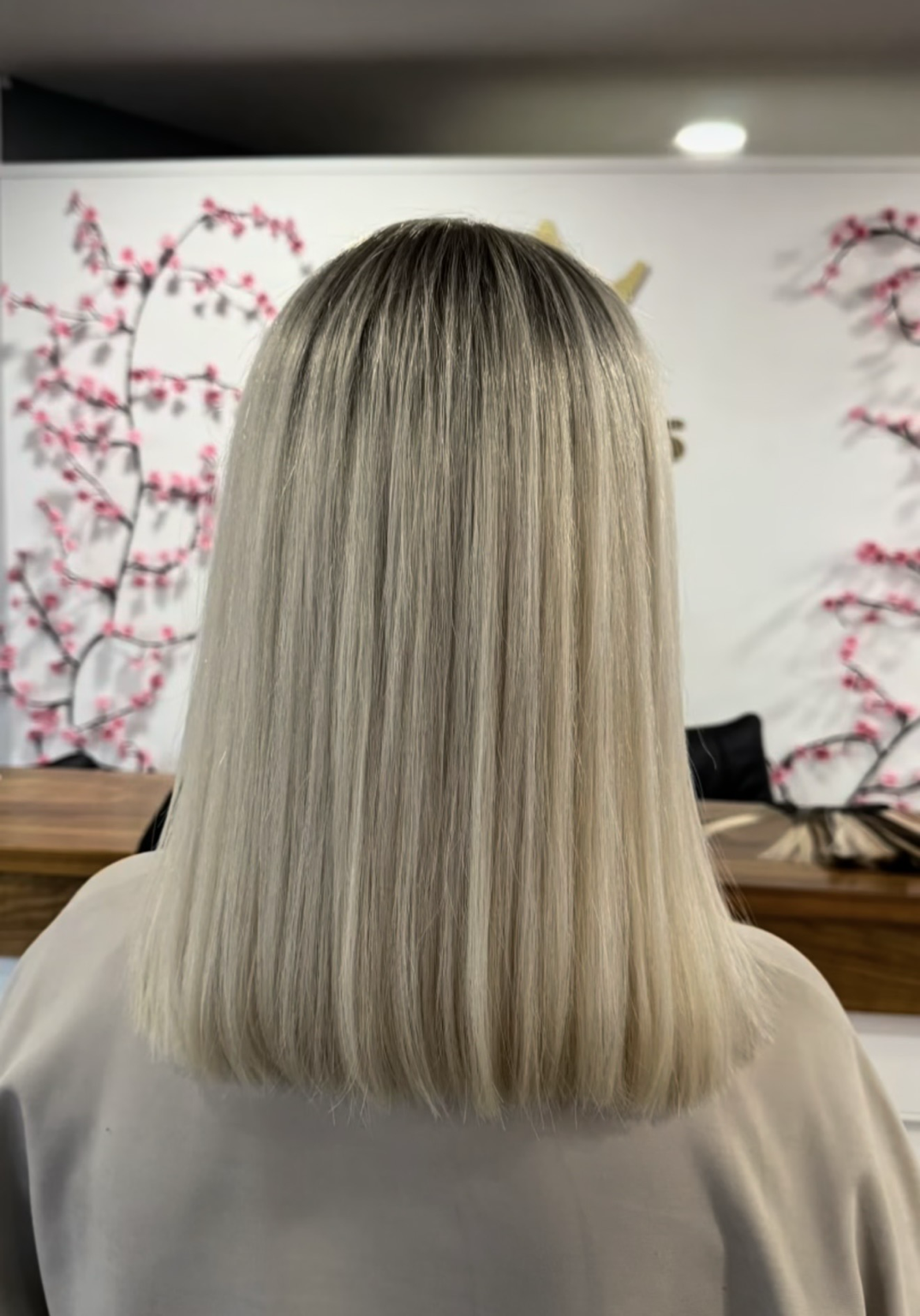 Straight shoulder length blonde hair, photographed from behind in the iHobbs salon.